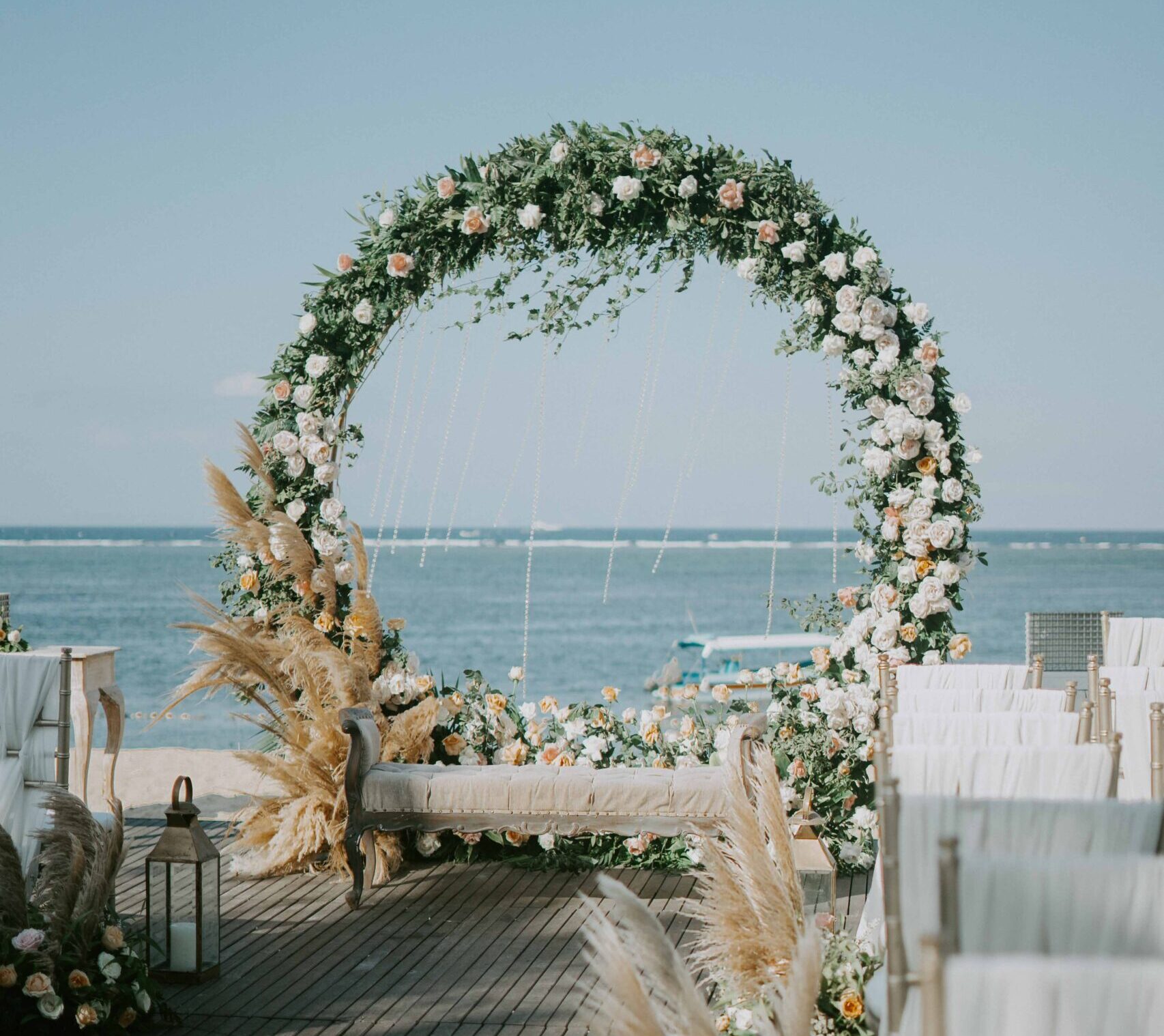 A floral wedding arch set for a Florida wedding on the water.